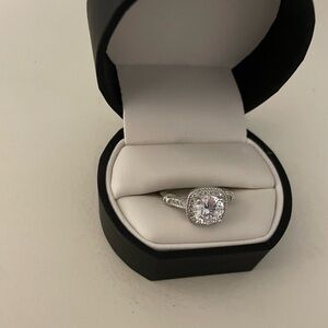 faux diamond and silver ring one large stone w/smaller accents. Size 7